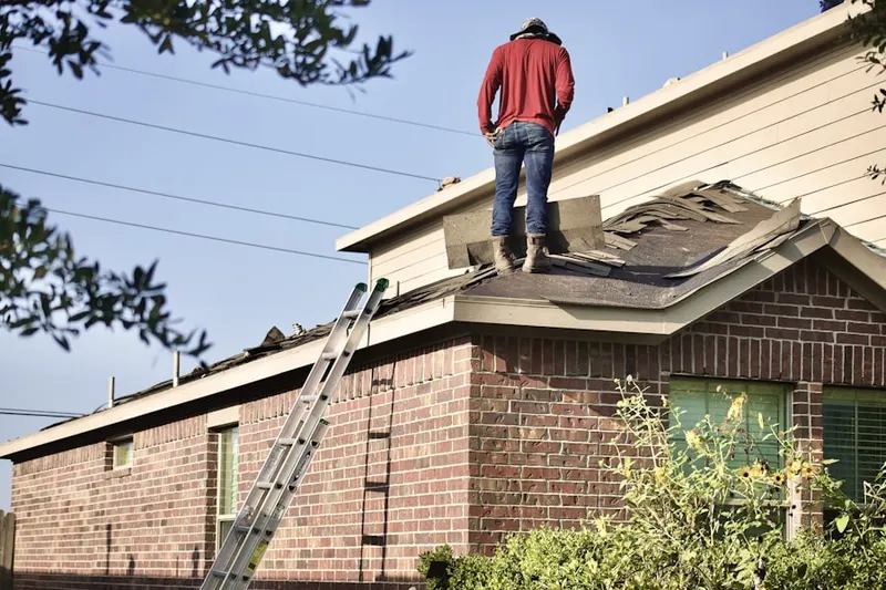 Professional roofer working on a residential roof in Palm View